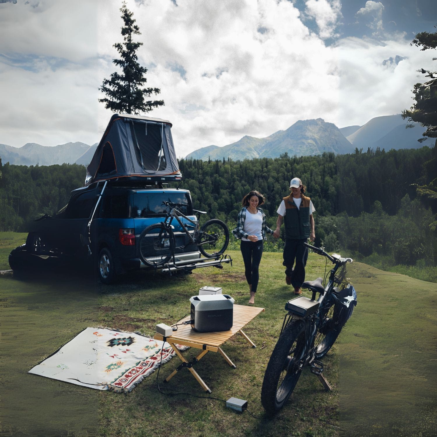 Two people camping in a field next to a car using the EcoFlow DELTA 3 Power Station to power their devices