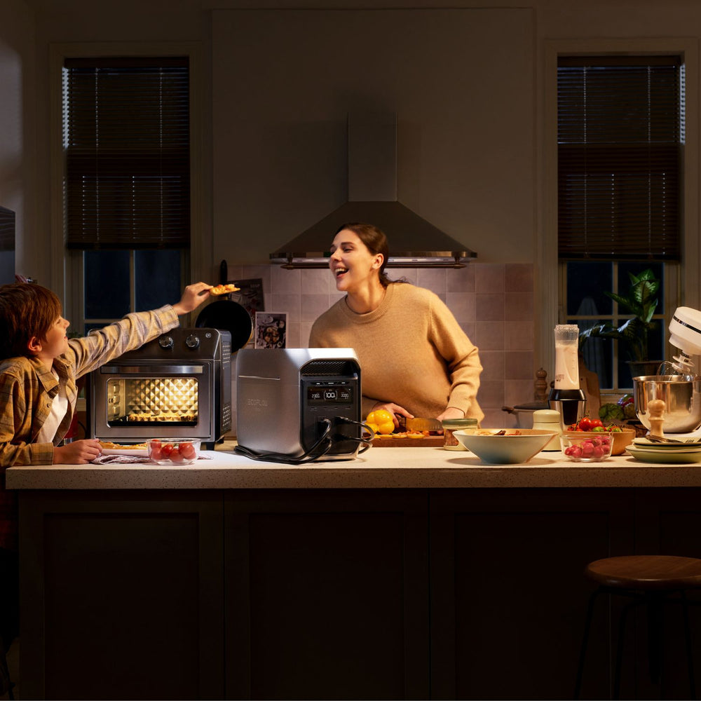 Two people in a kitchen preparing food with appliances connected to EcoFlow DELTA 3 Max Plus Portable Power Station.