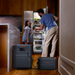 Two people in a kitchen with a Jackery HomePower 3600 Plus Portable Power Station connected to a refrigerator.