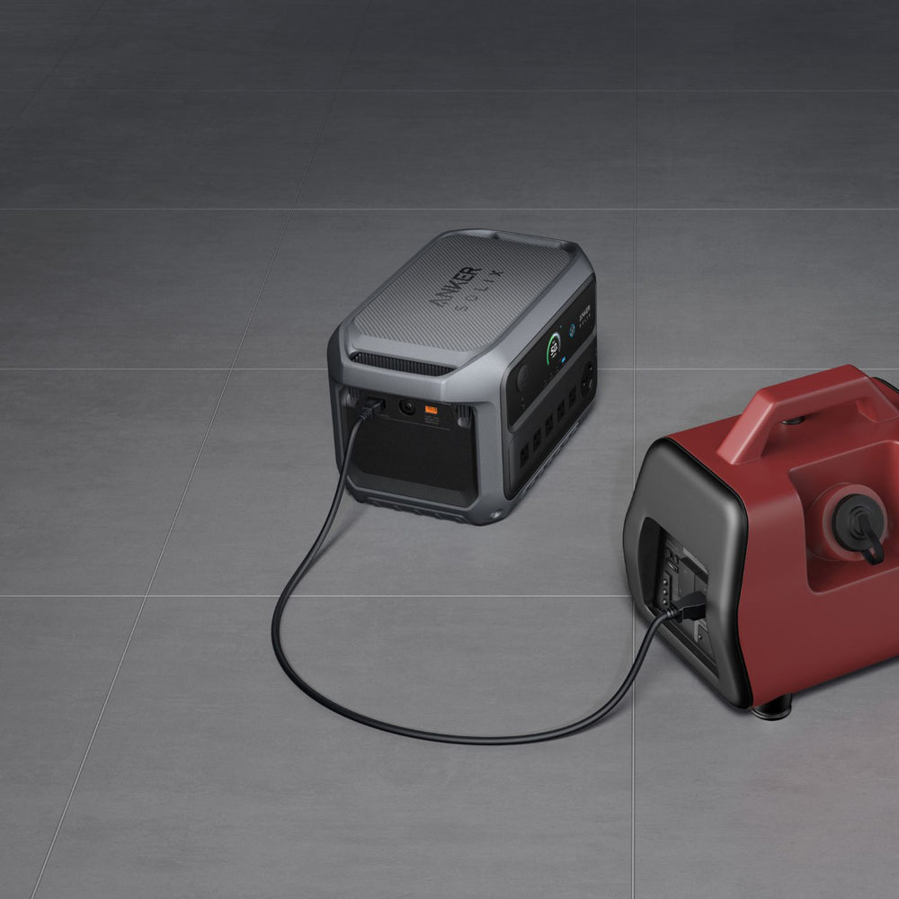 Two portable power stations, one Anker SOLIX C2000 Gen 2 Portable Power Station and one red, on a gray surface.