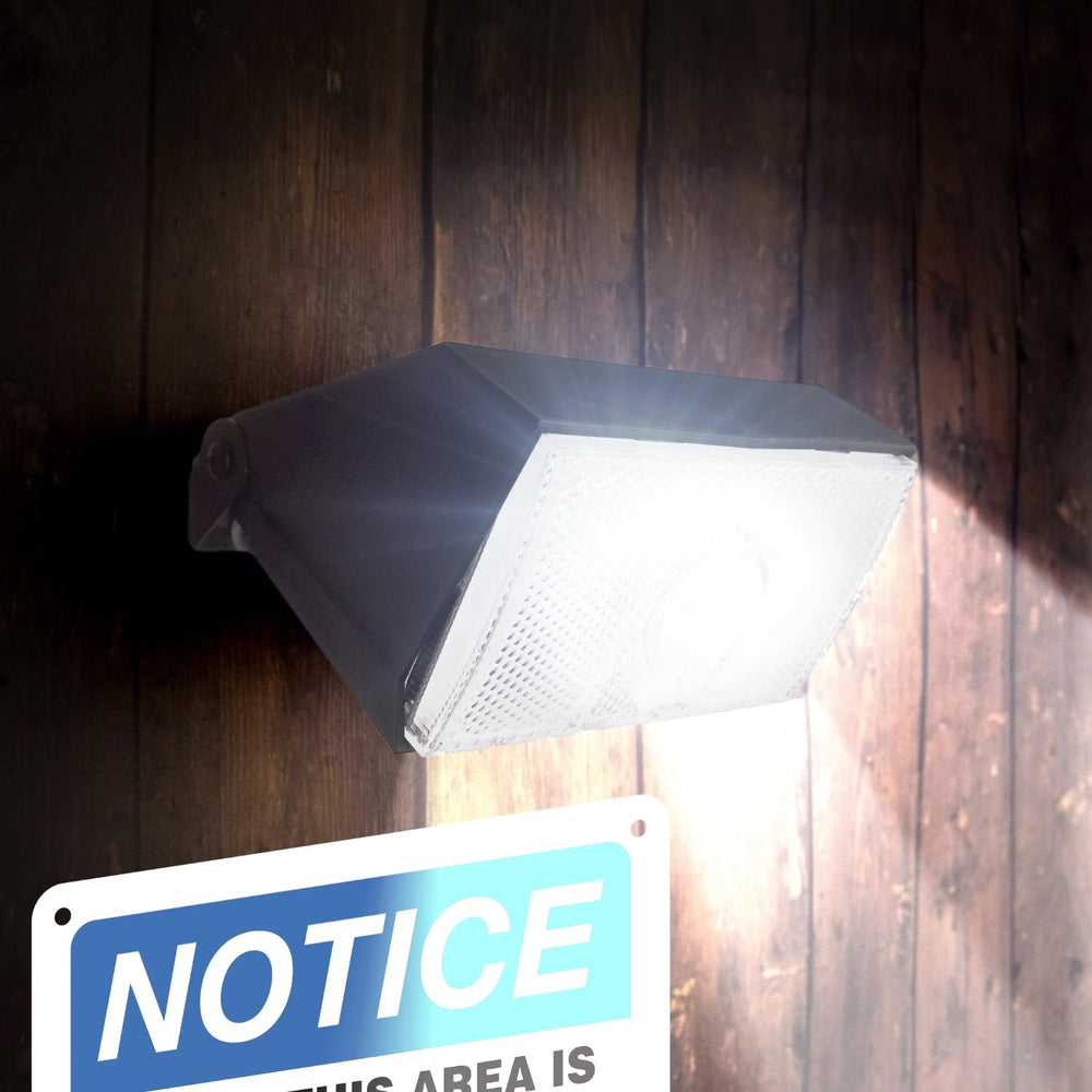 Wagan Tech 1000 Lumen Solar Wall Light On A Wall With Sign