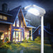 Wagan Tech Solar + LED Floodlight 2000 On A Pole In A Backyard