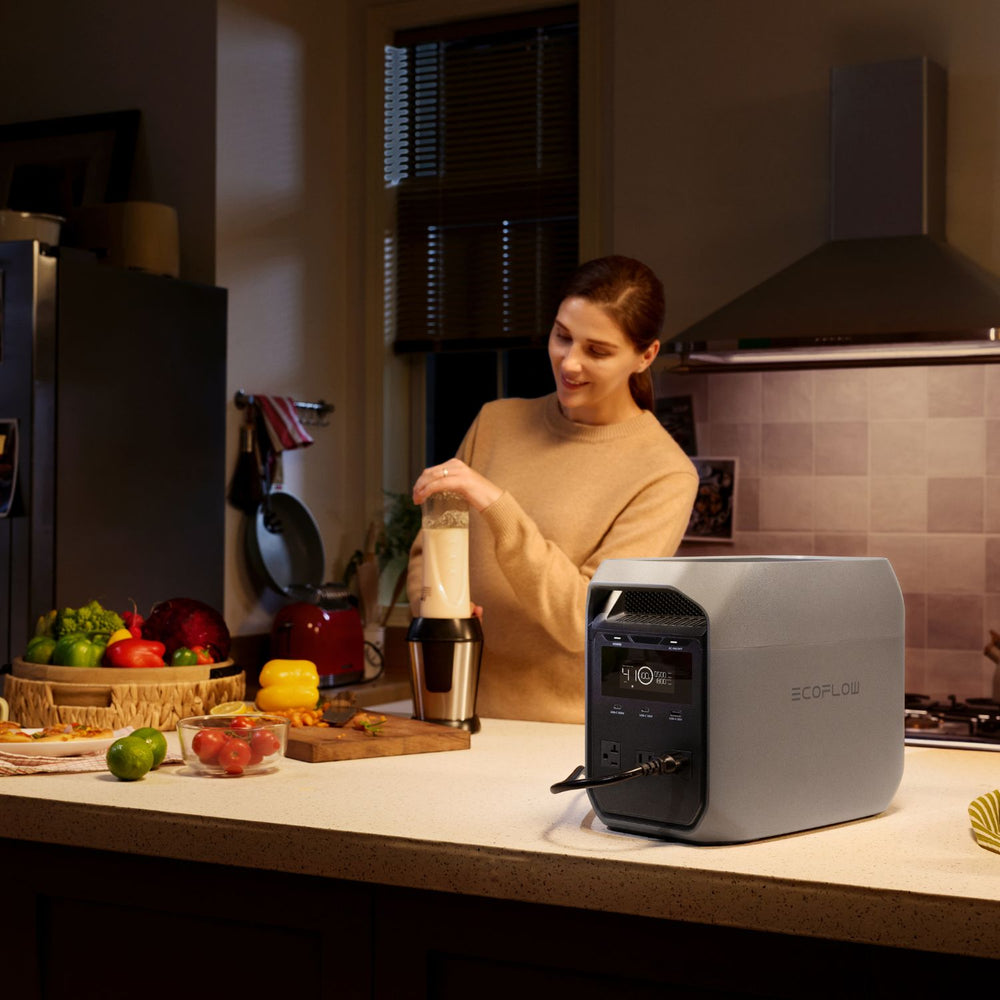 Woman in a kitchen using a blender connected to EcoFlow DELTA 3 Classic Portable Power Station