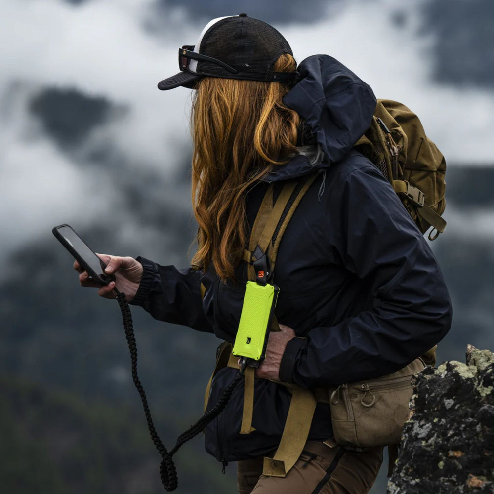 Woman using it while her phone connected to Dark Energy Poseidon Pro Power Bank - Green