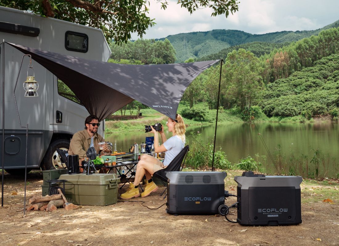 Couple camping by a lake next to an RV with EcoFlow portable power