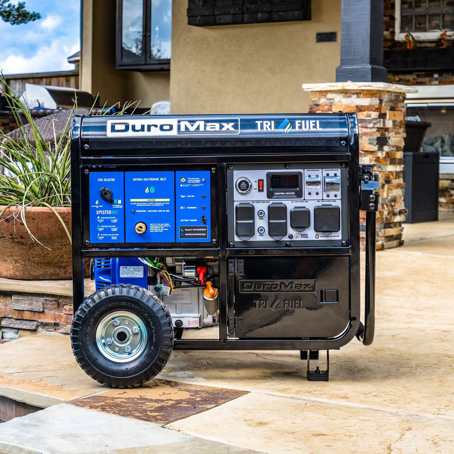 DuroMax XP13750HXT on a stone patio beside a house