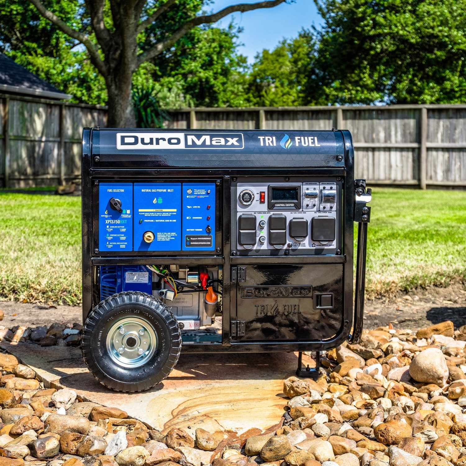 DuroMax XP13750HXT on river rock in a fenced backyard