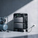 EcoFlow TITAN 5000 Plus on its wheeled base with an air compressor plugged into the front panel