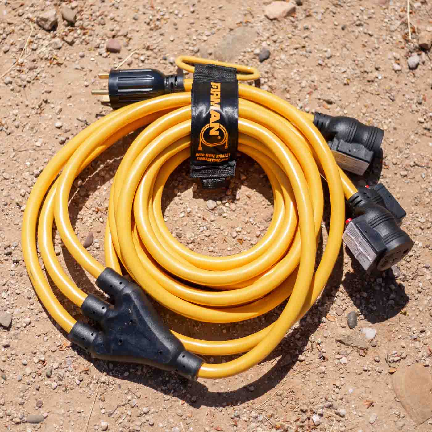 Firman 25' Heavy Duty TT-30P to (3)5-20R Portable Generator Power Cord With Storage Strap On The Ground