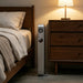 Jackery FridgeGuard on its vertical stands beside a bed in a bedroom
