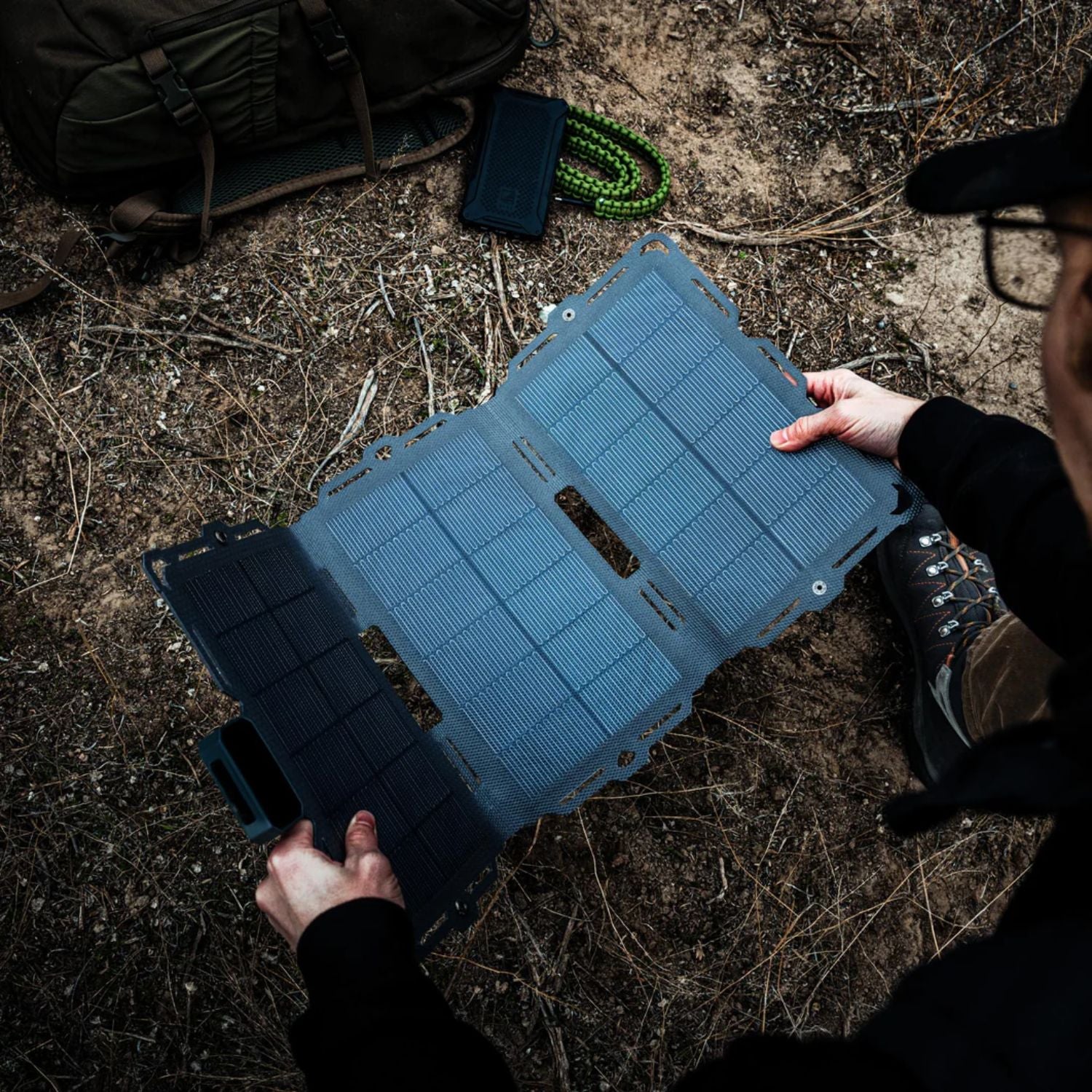 man holding the Dark Energy Spectre 18W Solar Panel - Gray 