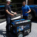 Two Men Discussing The DuroMax XP15000HXT Outdoors On A Driveway